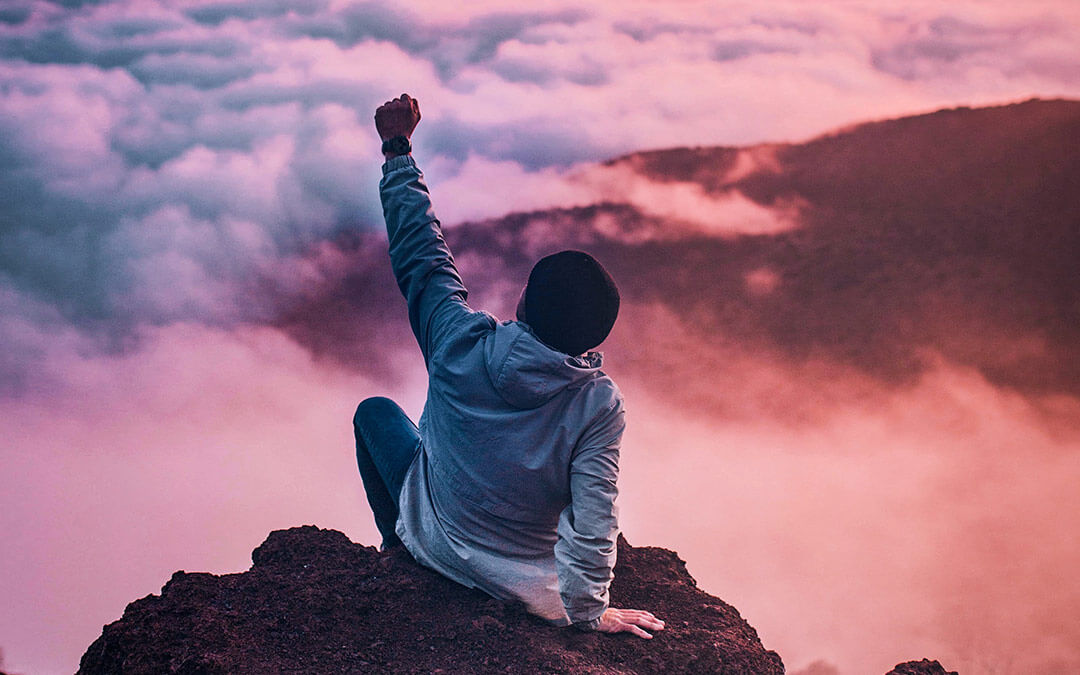 Man on mountain at sunset