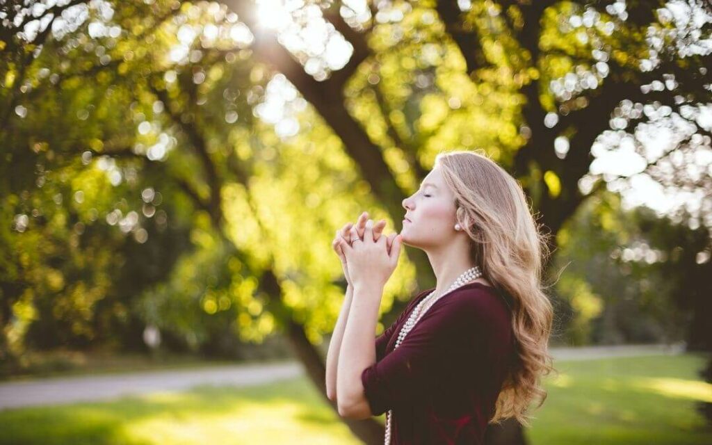 Woman meditating in garden