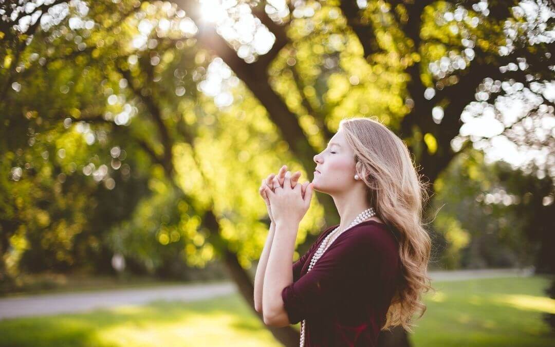 Woman meditating in garden
